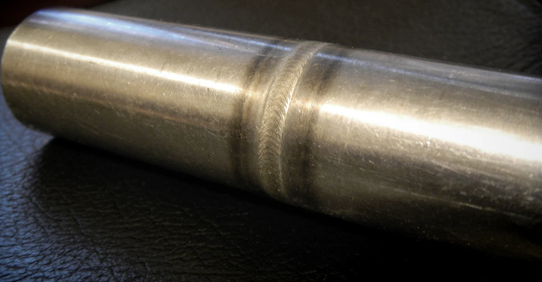 Close-up of a completed stainless steel orbital weld