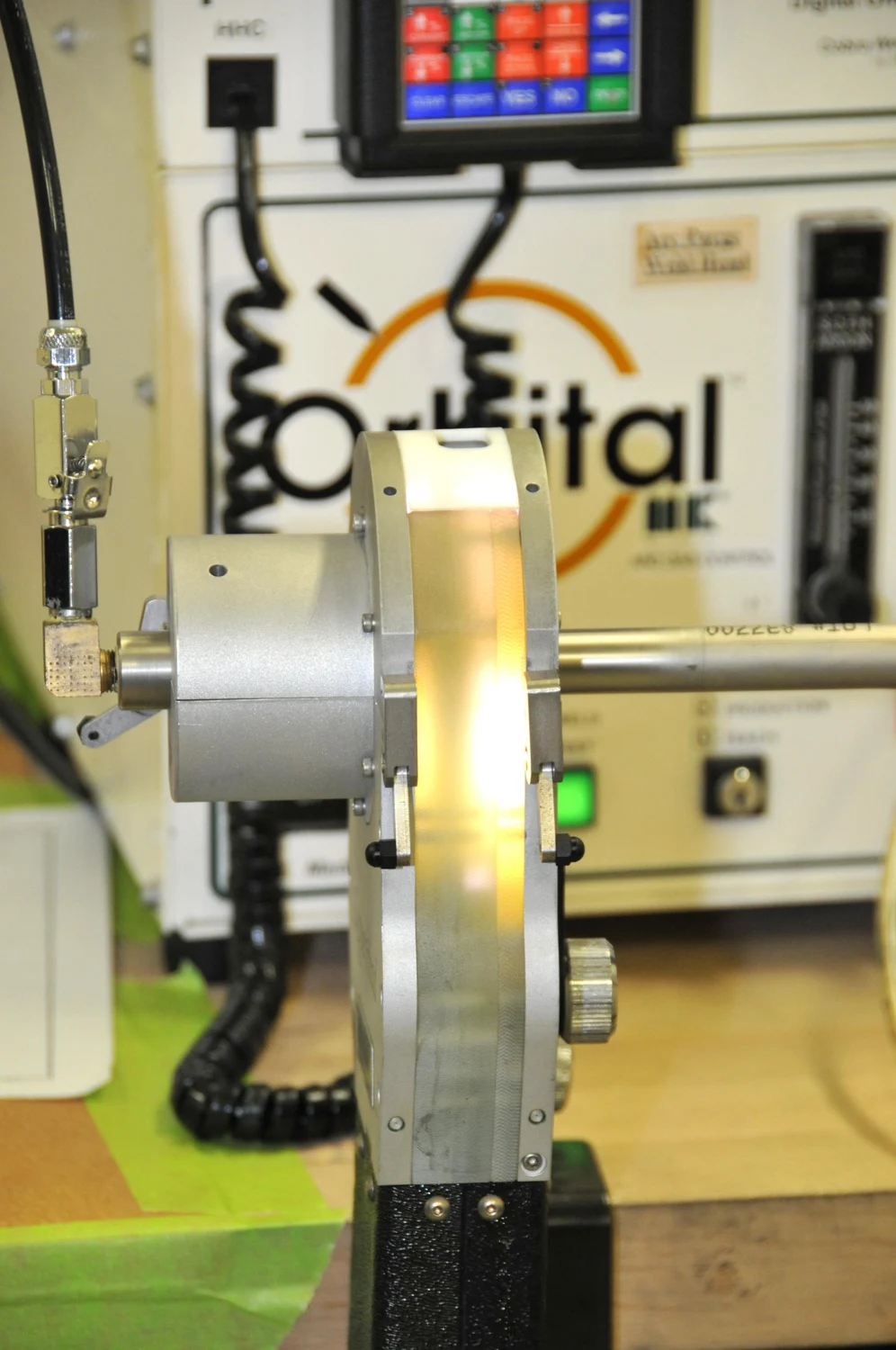 An automated orbital weld head performing a weld